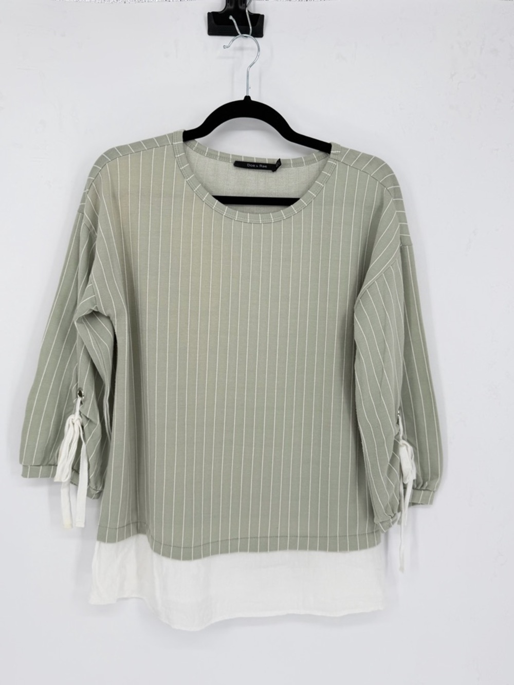 Preppy striped blouse sleeves with tie-detail cuffs and a layered hem